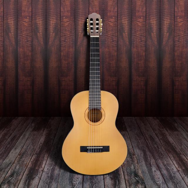 3/4 classical guitar featuring solid spruce top and engraved rosette