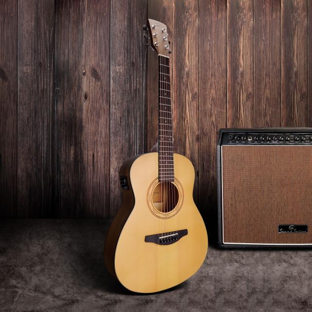 Compact Acoustic guitar featuring solid spruce top, engraved rosette and preamp